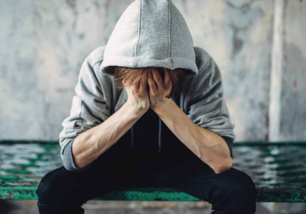 Person experiencing drug withdrawal and relapse, seeking addiction treatment.